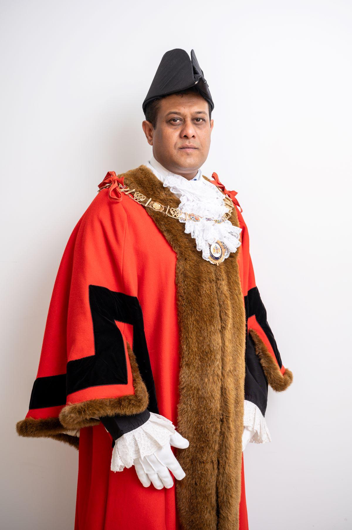 Mayor Moin Quadri standing in ceremonial robes looking into the camera camera 
