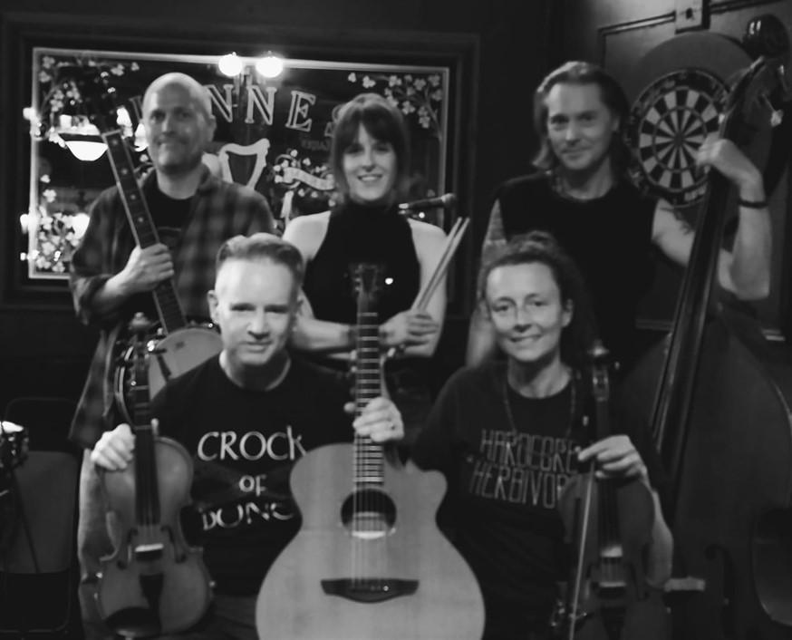 Black and White image of the Crock and Bones band looking into the camera 