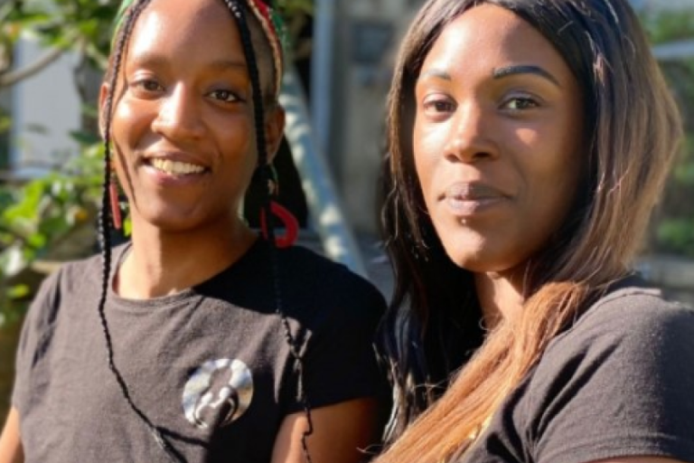 Portrait of two black women smiling in the camera