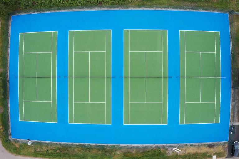 Aerial photo of four tennis courts