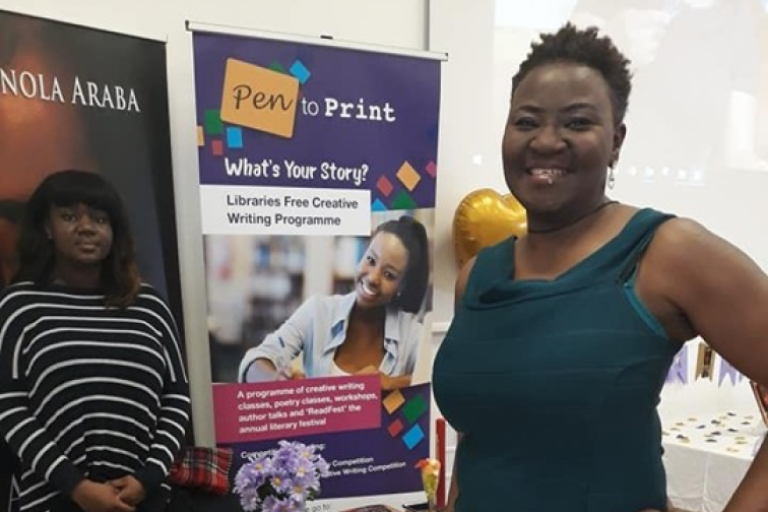 Photograph of a female, black writer promoting her book