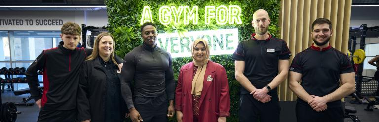 Harry, Cllr Ashraf and EA colleagues pose at entrance to gym